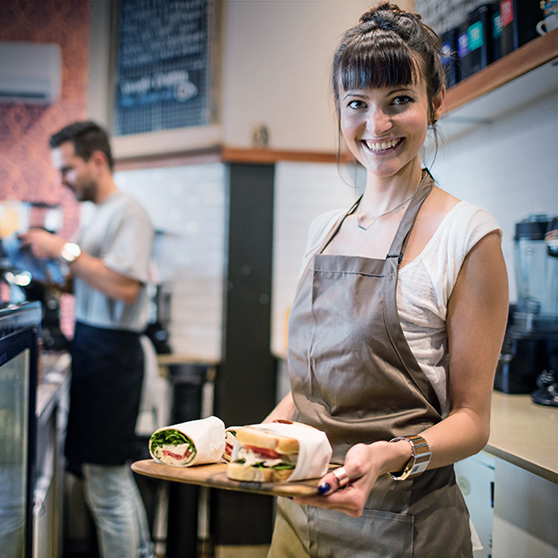 waitress serves wraps and sandwiches in coffee shop